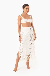 Falda midi de encaje blanco con abertura lateral y flecos en el ruedo.