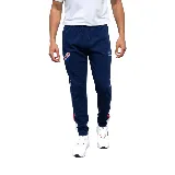 Pantalón de jogging azul marino con cordón ajustable en la cintura, bolsillos laterales y logo del Club Nacional de Football bordado en la pierna izquierda.
