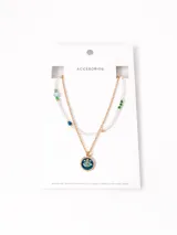 Collar doble dorado con cuentas de cristal y dije de ojo turco.