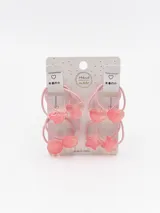 Pack de cuatro gomitas para el pelo, con elástico rosado y dijes de plástico transparente con forma de oso, círculo, corazón y estrella.