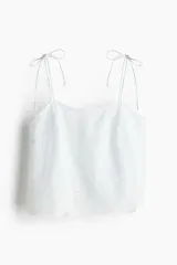 Top blanco con rayas verticales celestes, breteles finos con moñas y ribete festoneado con bordado calado en el bajo.