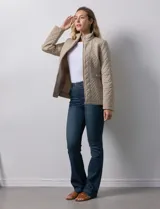 Campera capitoneada color beige, marca Gallery. Con cierre central, bolsillos delanteros con cierre, cinto de ajuste regulable en la cintura y forro interno a tono.