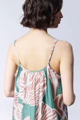 Vestido largo de algodón con estampado de hojas en tonos verde y rosa. Tiene tirantes finos y escote recto con fruncido.