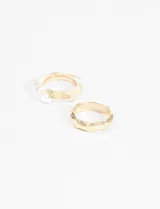 Set de anillos en diseños irregulares, uno plateado y otro dorado.