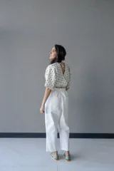 Top cruzado escotado de tusor de algodón con estampado de lunares verdes, cintura elastizada y manga corta holgada.