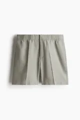 Short color gris claro confeccionado en mezcla de lino y algodón, corte regular, con cintura elástica, bolsillos laterales y trasero.