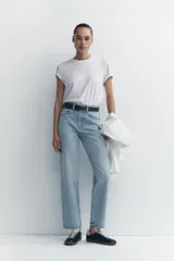 Pantalón de jean celeste de tiro alto, corte recto, con cinco bolsillos y cierre frontal con cremallera y botón metálico.