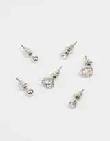 Set de tres pares de aros pasantes dorados con strass. Incluye un par de aros tipo bolita, un par con strass transparente y un par con strass y centro nacarado.