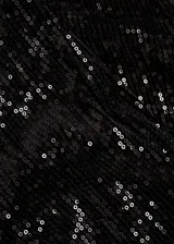 Calzas capri negras cubiertas de lentejuelas, con cintura elástica y corte skinny.