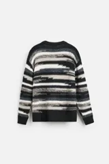 Jersey de hombre con corte relaxed, cuello redondo y manga larga. Diseño con patrón geométrico jacquard en tonos negro, gris y blanco.
