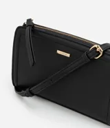 Cartera transversal pequeña de PU color negro, con cierre de cremallera y correa larga.