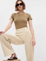 Pantalón de jean color beige, de tiro alto y corte wide leg.
