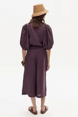 Bermuda color morado con diseño a cuadros, de tiro alto, corte amplio y largo a la rodilla.