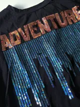 Remera negra de mangas cortas con estampado frontal con texto y diseño de cascada azul.