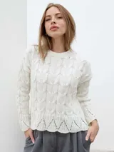 Sweater blanco de tejido de punto con diseño calado y cuello redondo.