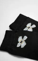 Medias negras con diseño de billetes de dólar.
