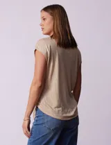 Blusa de modal con estampado de hojas en tonos azulados, escote en V con botones y ruedo anudado.