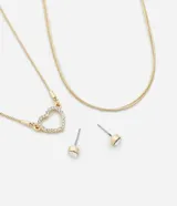 Conjunto de collar dorado de doble cadena, uno con colgante de corazón con strass y otro liso, con aros dorados con strass.