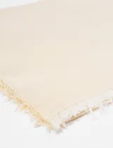 Pashmina de algodón y poliéster con franjas y flecos, en tono verde claro.