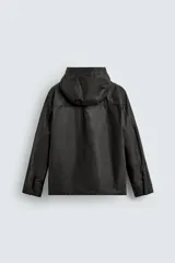Parka relaxed fit color negro confeccionada en tejido de lino que repele el agua. Tiene cuello con capucha ajustable, mangas largas con puños abotonados, bolsillos frontales con solapa y cierre frontal con cremallera oculta por solapa con botones a presión.