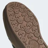 Championes Adidas Gazelle Bold negros con plataforma color caramelo y las tres tiras blancas a los costados.