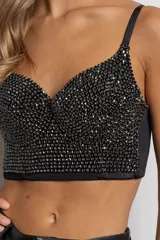 Top bustier negro con apliques de piedras negras brillantes, espalda elastizada y tirantes regulables.