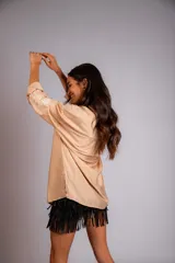 Camisa celeste de corte clásico, con botones frontales y bordados florales en las mangas.