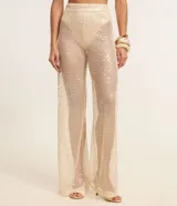 Pantalón femenino estilo pantalona de corte amplio, color beige claro, con superposición de lentejuelas y forro interior tipo bombacha cavada.