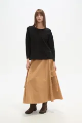 Sweater blanco liso, de corte holgado, con cuello a la base y broches decorativos en los laterales.