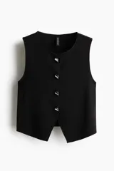 Chaleco negro entallado de punto suave, con cuello redondo y botones metálicos plateados en el frente.