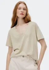 Remera color verde claro con cuello en V y mangas cortas. Corte recto y holgado.