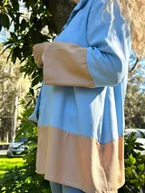 Camisa celeste y beige de lino, de corte recto, manga larga y cuello clásico.