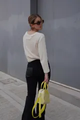 Pantalón de jean negro de corte recto y tiro alto, con bolsillos delanteros y traseros.