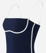 Vestido midi azul marino con breteles finos ajustables y bies contrastante blanco en el busto y ruedo. Confeccionado en algodón certificado BCI.