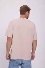 Camiseta de manga corta color beige con bloque central blanco con la palabra "Originals" en relieve.