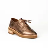 Zapato acordonado color bronce de cuero vacuno con perforaciones decorativas, taco de madera con folia en cuero de 4cm y entre suela de goma de 1,5cm. Horma de punta redonda y cómoda.