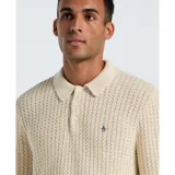 Sweater tipo polo de manga larga color crema, tejido en algodón con trama zigzag y logo bordado en el pecho.