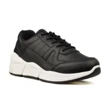 Zapatillas deportivas negras con suela blanca gruesa y diseño geométrico.