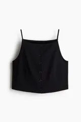Chaleco negro con breteles spaghetti y cierre frontal con botones. Corte ajustado y forro interior.