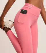 Calza deportiva larga color rosa, confeccionada en microfibra, con cintura alta con elástico porta remera y bolsillo lateral.