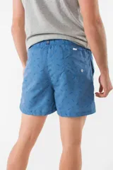 Short de baño azul con estampado de hojas de palmera en tonos azules, blancos y rosados.