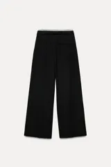 Pantalón ancho gris con textura de espiga, tiro alto, doble cintura elástica ajustable con cordón, pinzas frontales, bolsillos delanteros y falso bolsillo de vivo en la espalda.