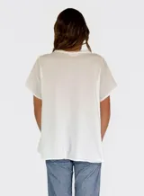 Camisa de lino y algodón color rosa claro, con cuello en V, mangas cortas y volados frontales.