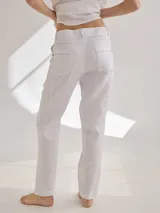 Pantalón cigarette de lino color ladrillo, de tiro alto y corte recto.