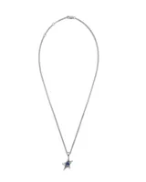 Collar de plata 925 con cadena tipo cordón y dije de estrella de plata con una piedra central redonda de color azul.