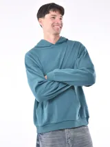 Buzo hoodie color verde azulado, de corte holgado, con capucha y bolsillo tipo canguro.
