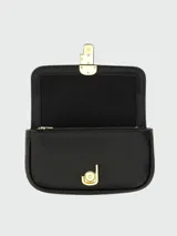 Bolso bandolera Marc Jacobs The Mini, color crema, con correa ancha de tela con logo de la marca y cadena dorada decorativa.