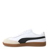 Championes Puma 9T W, color negro con detalles en blanco y suela color caramelo.
