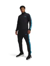 Conjunto deportivo Under Armour gris con detalles en negro. Incluye campera con cierre y pantalón con cintura elástica y cordón ajustable. Ambos con logo de la marca en el pecho y en la pierna.