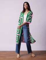 Cardigan largo tejido al crochet con diseño geométrico en verde y rosa. Tiene mangas 3/4 y corte holgado.